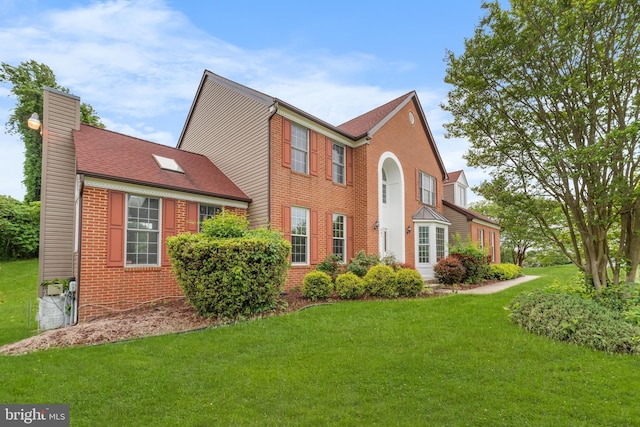 601 James Ridge Rd, Bowie, MD 20721 - rear view of house with a chimney, brick siding, and a yard
