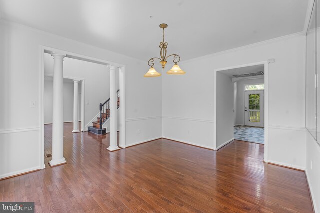 601 James Ridge Rd, Bowie, MD 20721 - unfurnished dining area with wood finished floors, crown molding, stairs, and baseboards