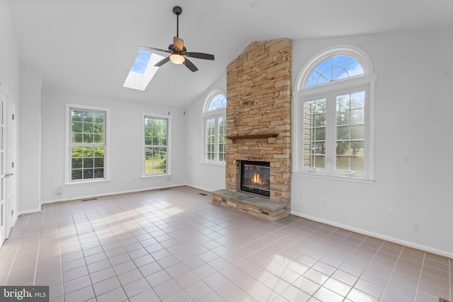 601 James Ridge Rd, Bowie, MD 20721 - unfurnished living room featuring healthy amount of natural light, a ceiling fan, a fireplace, a skylight, and high vaulted ceiling