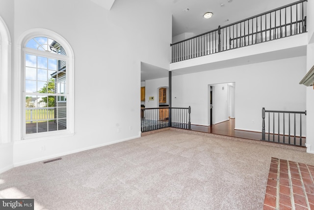 601 James Ridge Rd, Bowie, MD 20721 - unfurnished living room with a towering ceiling, carpet, and baseboards