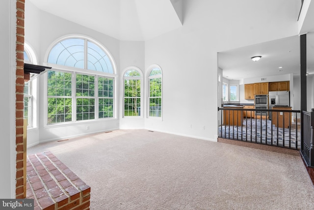 601 James Ridge Rd, Bowie, MD 20721 - unfurnished living room with baseboards, carpet flooring, and a towering ceiling