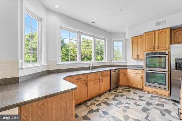 601 James Ridge Rd, Bowie, MD 20721 - kitchen with a sink, stainless steel appliances, dark countertops, and recessed lighting