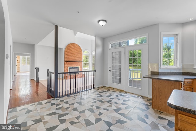 601 James Ridge Rd, Bowie, MD 20721 - doorway to outside featuring healthy amount of natural light, a brick fireplace, and baseboards