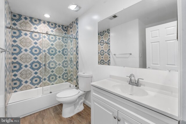 601 James Ridge Rd, Bowie, MD 20721 - full bath with toilet, wood finished floors, vanity, combined bath / shower with glass door, and recessed lighting