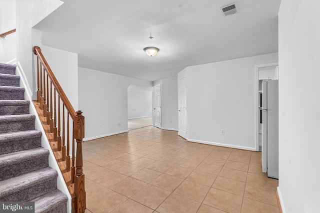 601 James Ridge Rd, Bowie, MD 20721 - unfurnished room featuring light tile patterned floors, stairs, and baseboards