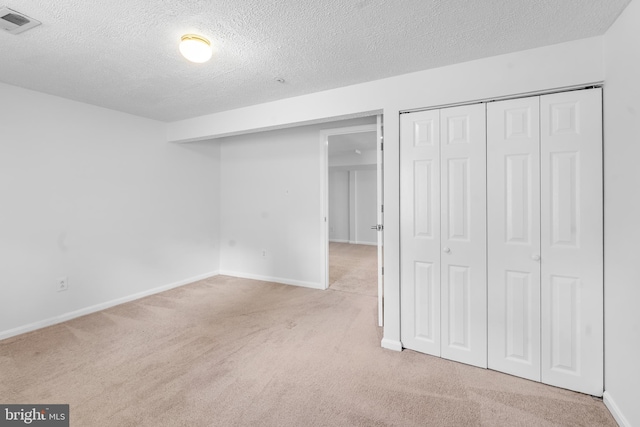 601 James Ridge Rd, Bowie, MD 20721 - unfurnished bedroom with carpet floors, a textured ceiling, baseboards, and a closet
