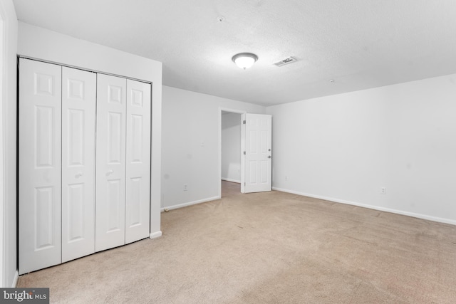 601 James Ridge Rd, Bowie, MD 20721 - unfurnished bedroom with carpet, baseboards, a closet, and a textured ceiling