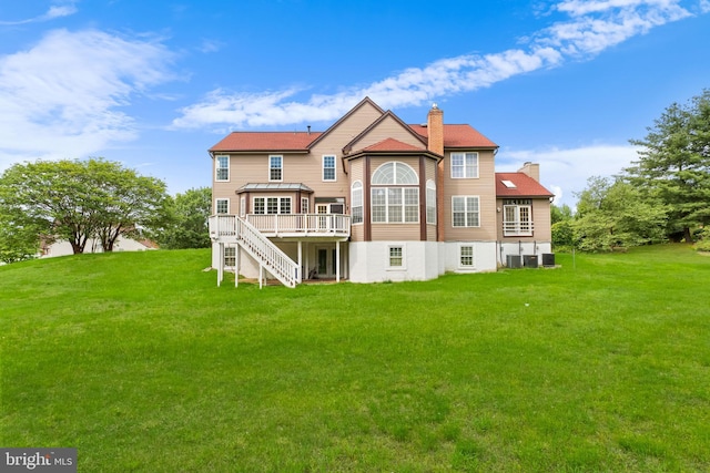 601 James Ridge Rd, Bowie, MD 20721 - rear view of house with a chimney, a wooden deck, stairway, and a yard