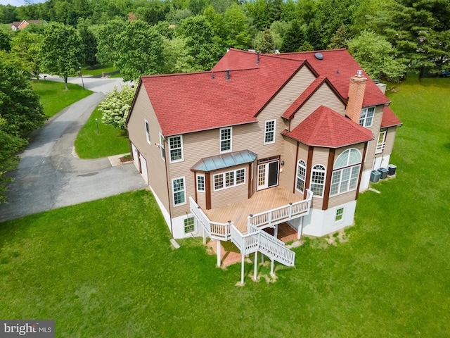 601 James Ridge Rd, Bowie, MD 20721 - back of house with a lawn, a shingled roof, a garage, and asphalt driveway