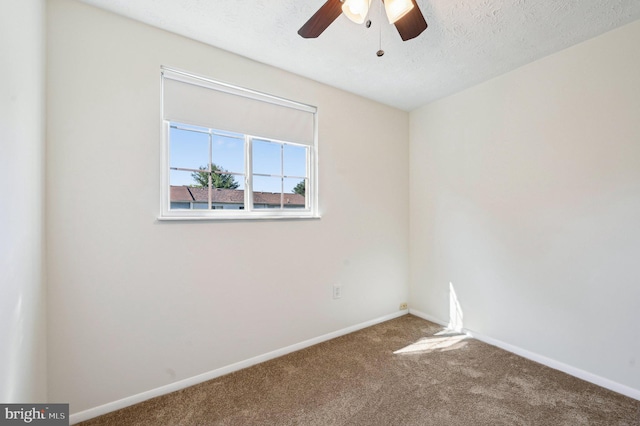 empty room with carpet, ceiling fan, and baseboards