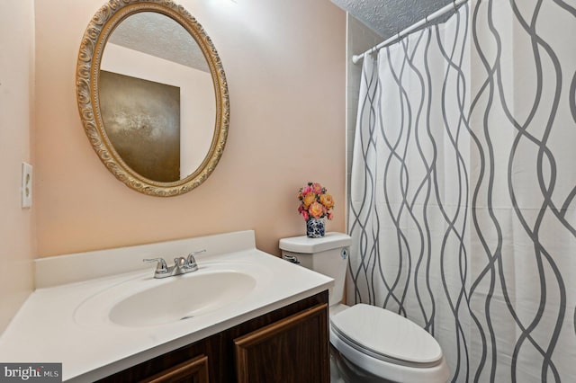 bathroom featuring a textured ceiling, toilet, vanity, and a shower with shower curtain