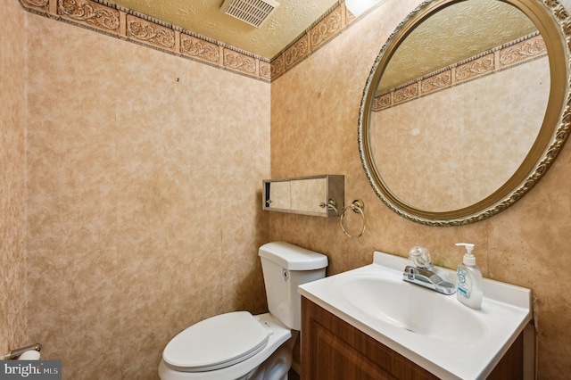 bathroom with toilet and vanity