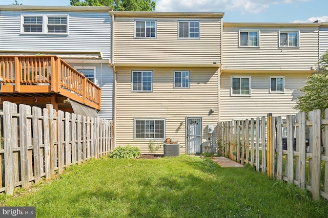 back of house featuring a wooden deck