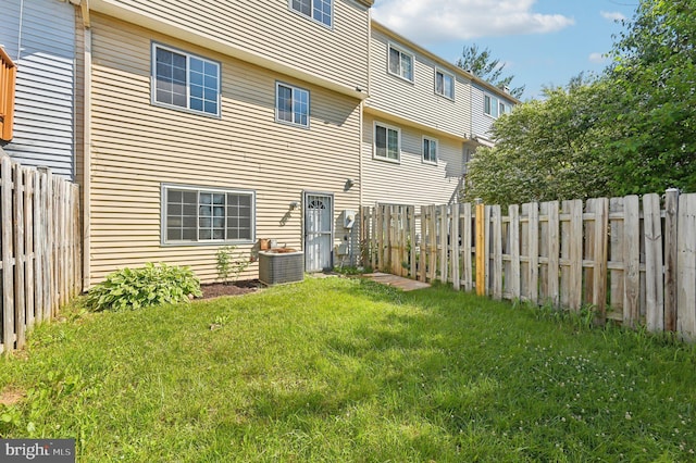back of house with central AC
