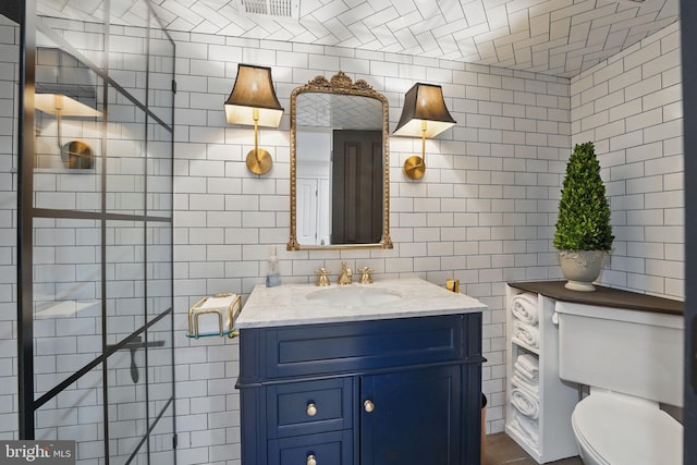 624 14th St NE, Washington, DC 20002 - bathroom featuring tile walls, toilet, and vanity