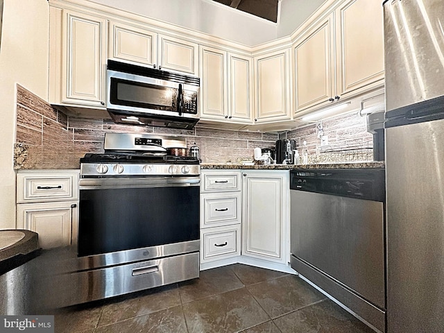 7839 Enola St Unit 204, Mclean, VA 22102 - kitchen featuring appliances with stainless steel finishes, cream cabinetry, dark tile patterned flooring, and backsplash