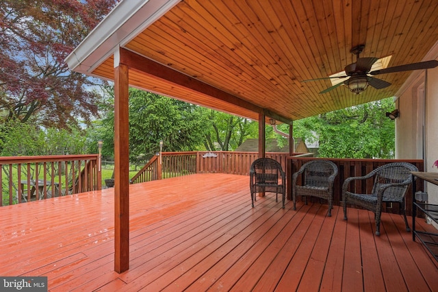 wooden terrace featuring ceiling fan