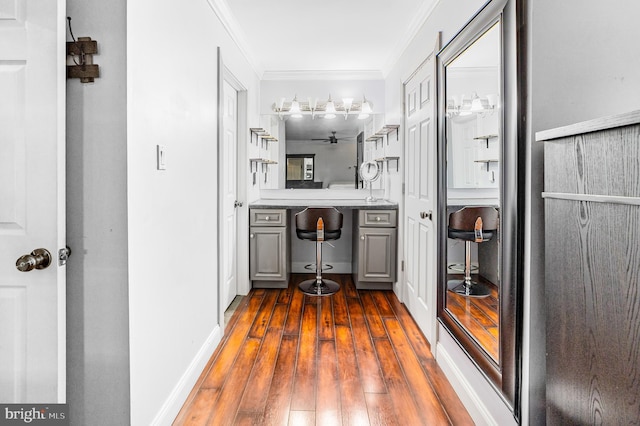bathroom with crown molding, hardwood / wood-style floors, and baseboards