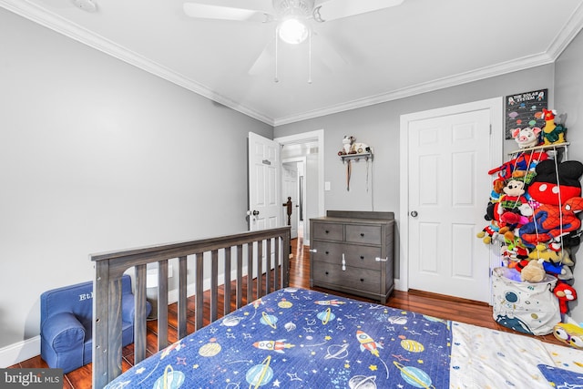 bedroom featuring wood finished floors, crown molding, baseboards, and ceiling fan