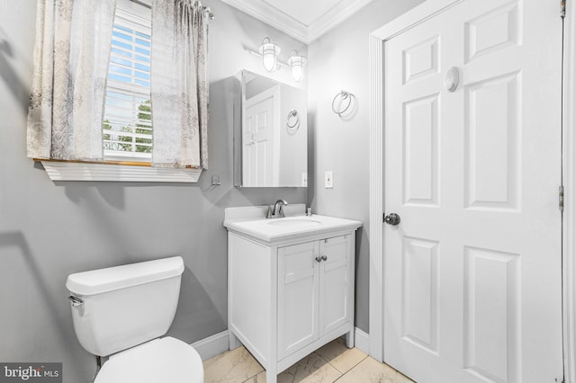 half bath featuring ornamental molding, baseboards, marble finish flooring, toilet, and vanity