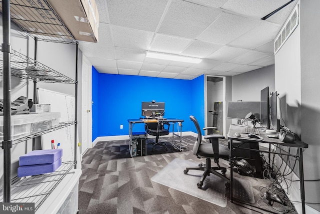 office area featuring baseboards, a drop ceiling, and carpet