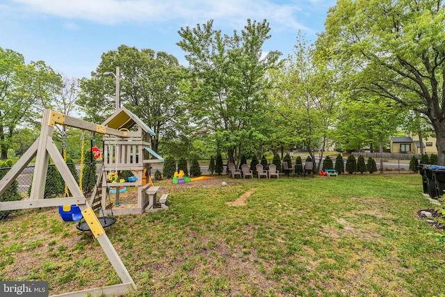 view of yard with a playground and view of scattered trees