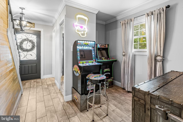 recreation room with a chandelier, wood tiled floors, baseboards, and crown molding