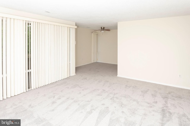 unfurnished living room featuring carpet flooring and baseboards