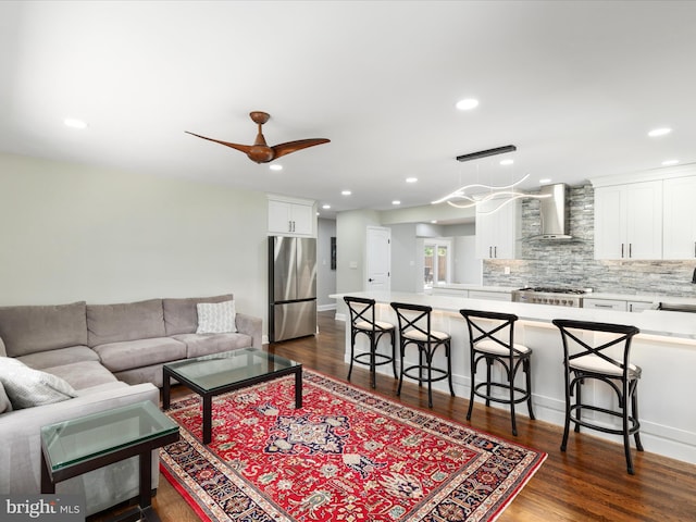 living room with dark wood finished floors, recessed lighting, and ceiling fan