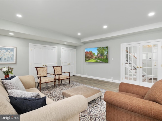 living room featuring wood finished floors, recessed lighting, baseboards, and stairway
