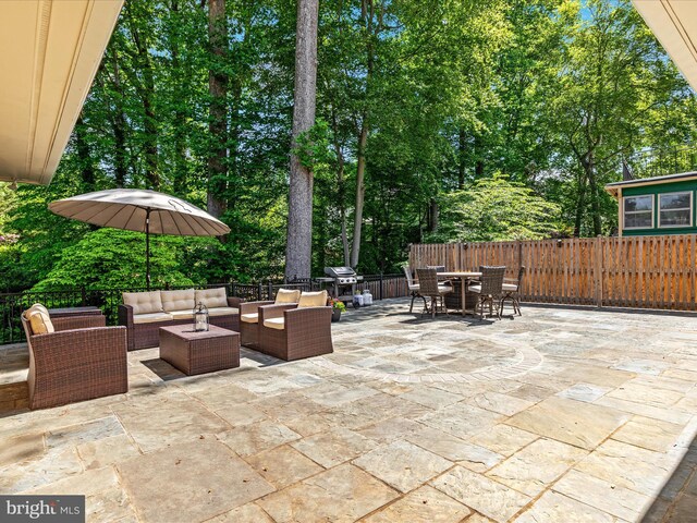 view of patio / terrace with outdoor dining area, an outdoor living space, a fenced backyard, area for grilling, and view of scattered trees