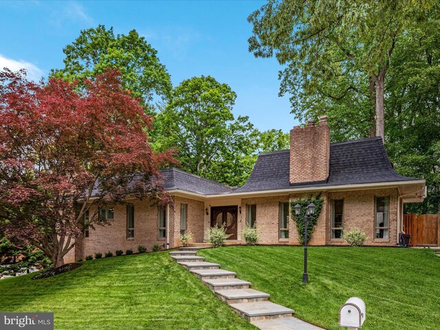 view of front of property with brick siding, a shingled roof, and a chimney
