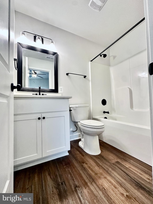 304 1st St, Colonial Beach, VA 22443 - full bathroom featuring toilet, tub / shower combination, wood finished floors, visible vents, and vanity