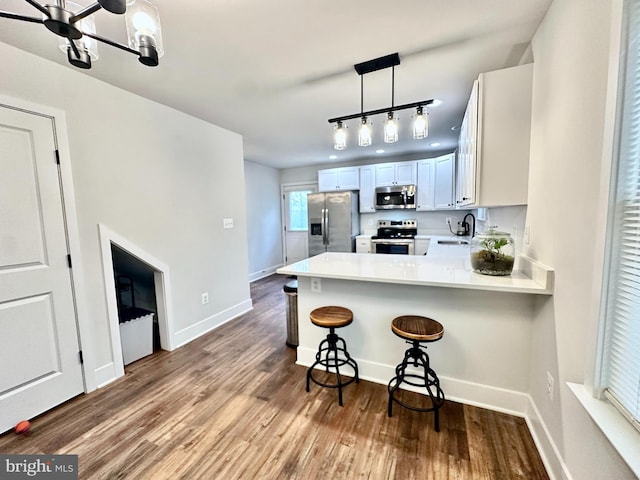 304 1st St, Colonial Beach, VA 22443 - kitchen featuring light countertops, appliances with stainless steel finishes, and dark wood-style flooring