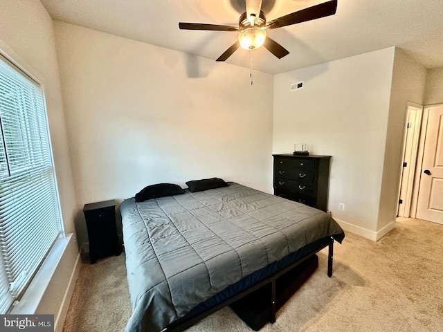 304 1st St, Colonial Beach, VA 22443 - bedroom with baseboards, light carpet, visible vents, and a ceiling fan