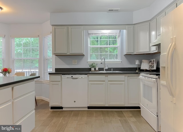 411 N Ln, Prince Frederick, MD 20678 - kitchen featuring white appliances, a sink, dark countertops, and light wood-style flooring