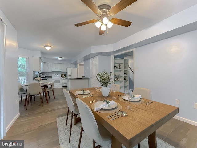 411 N Ln, Prince Frederick, MD 20678 - dining space featuring a ceiling fan, stairway, baseboards, and light wood finished floors