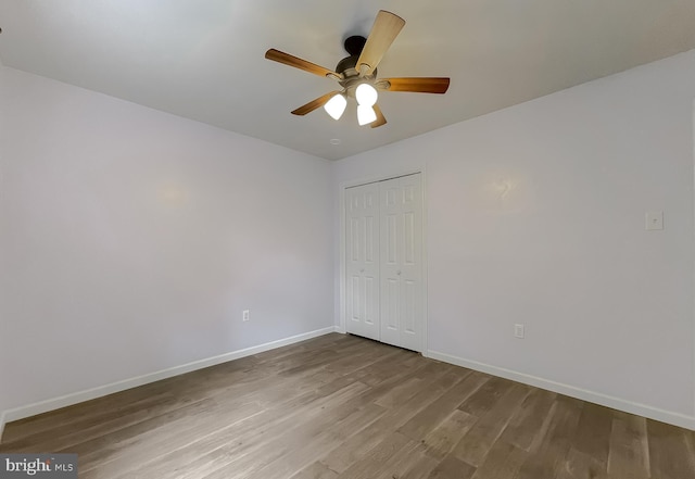 411 N Ln, Prince Frederick, MD 20678 - unfurnished bedroom featuring wood finished floors, baseboards, a closet, and a ceiling fan