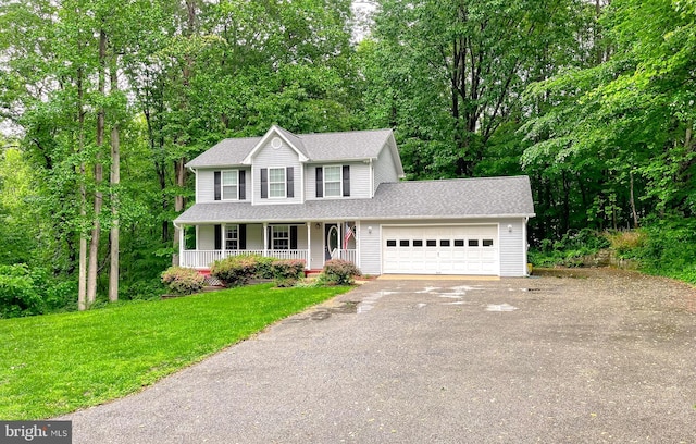 411 N Ln, Prince Frederick, MD 20678 - colonial inspired home featuring an attached garage, driveway, covered porch, a front lawn, and a shingled roof
