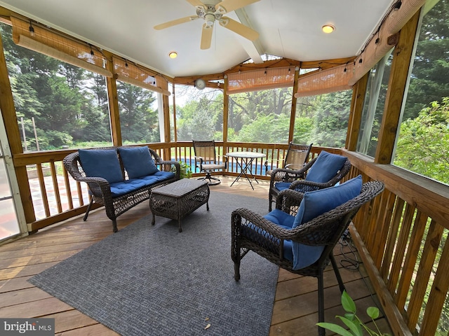 sunroom / solarium featuring a ceiling fan and an outdoor hangout area