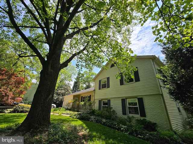 view of home's exterior with a yard