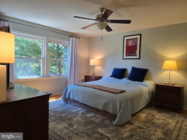 bedroom with baseboards, ceiling fan, and wood finished floors