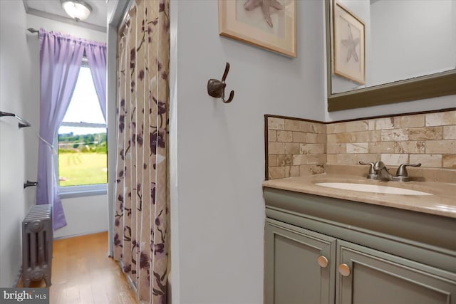 2050 Legion Rd, Clearfield, PA 16830 - full bath with vanity, radiator heating unit, wood finished floors, backsplash, and a shower with curtain