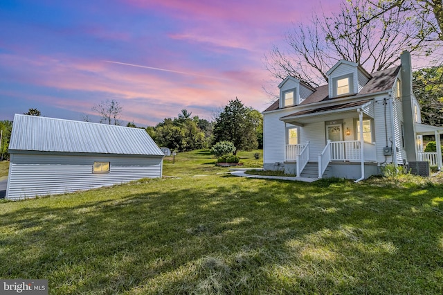 view of yard featuring a porch and central AC