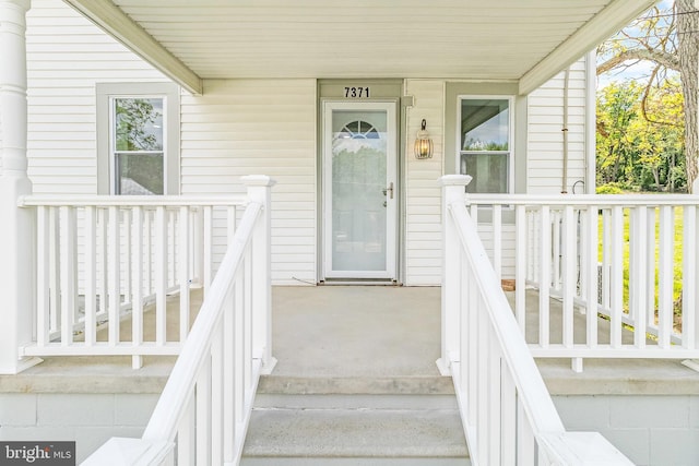 property entrance with covered porch