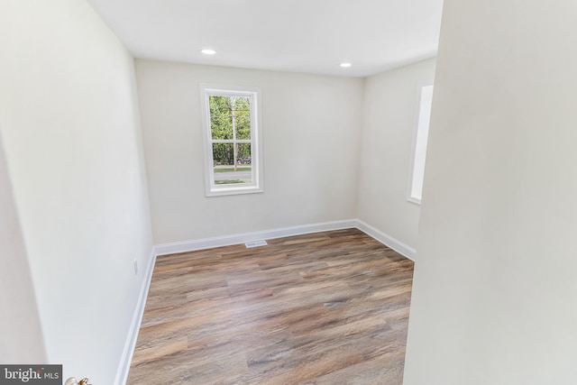 spare room featuring visible vents, wood finished floors, baseboards, and recessed lighting