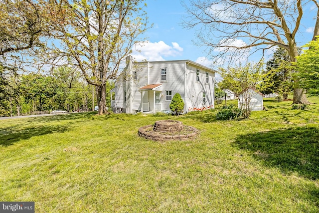 view of home's exterior with a yard and a chimney