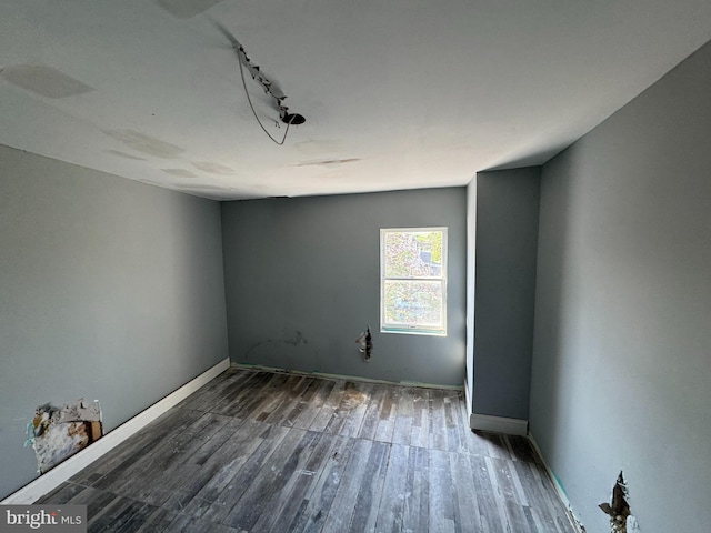1505 Ramsay St, Baltimore, MD 21223 - empty room featuring baseboards, rail lighting, and wood finished floors