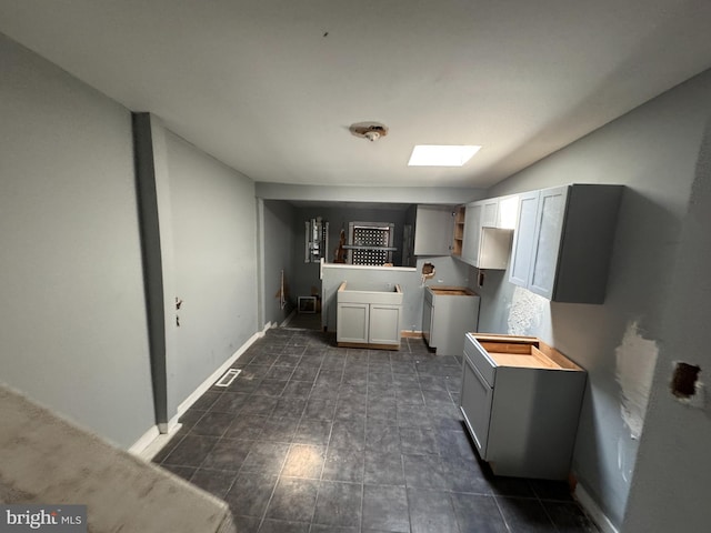 1505 Ramsay St, Baltimore, MD 21223 - laundry area with baseboards and a skylight