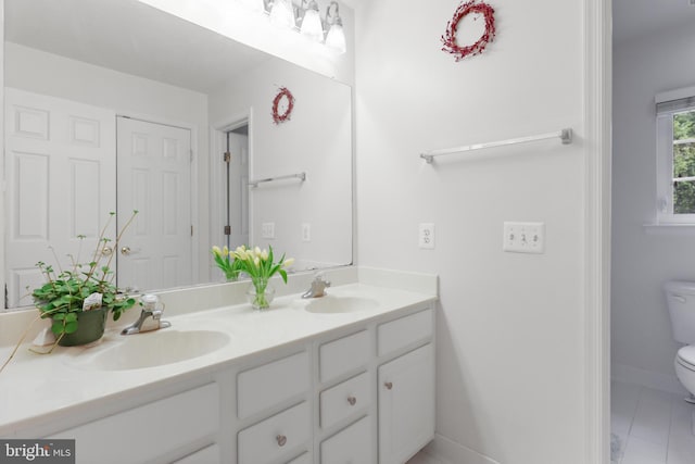 11404 Ramsburg Ct, North Potomac, MD 20878 - bathroom featuring toilet, double vanity, baseboards, and tile patterned floors
